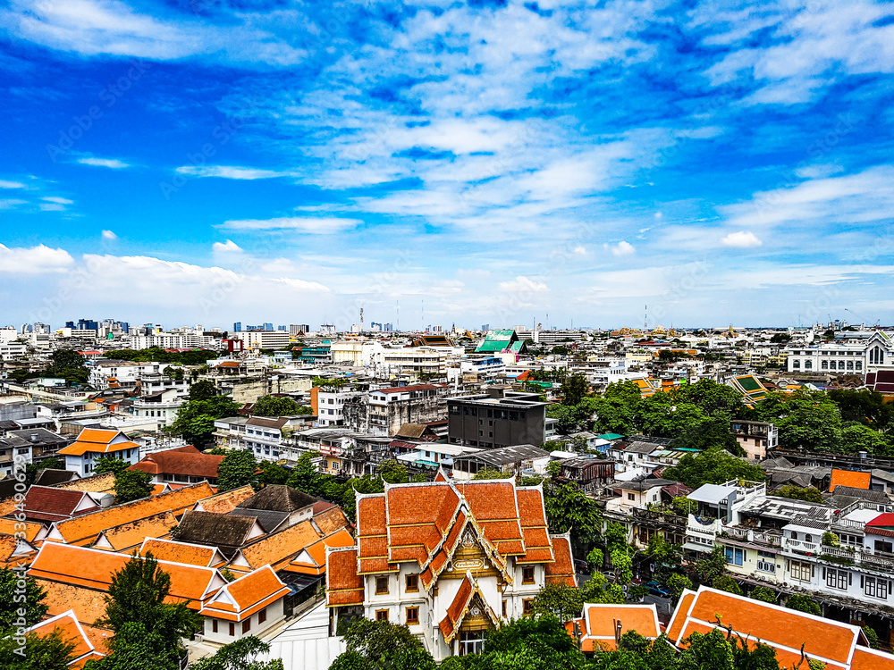 Over the roofs of Bangkok like a painting with the sky and clouds