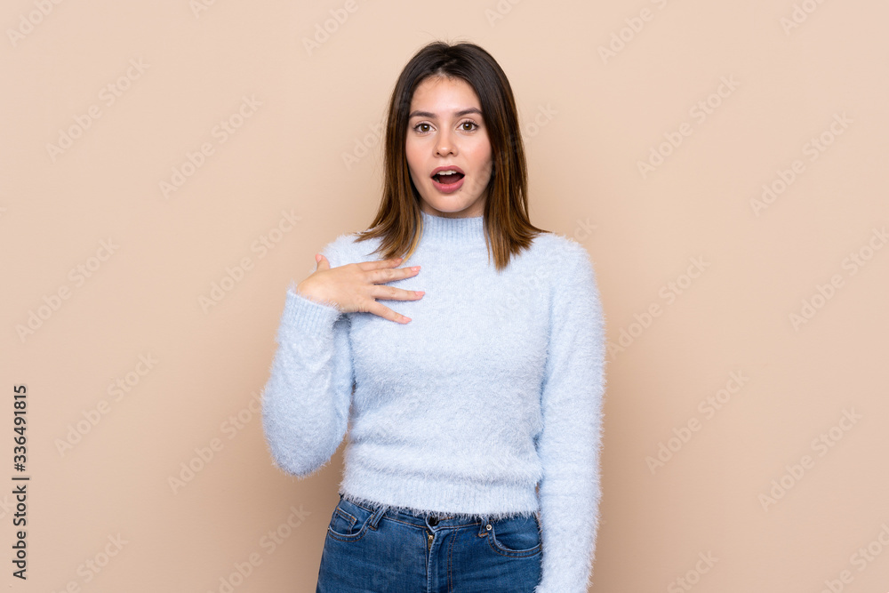 Young woman over isolated background surprised and shocked while looking right Young woman over isolated background surprised and shocked while looking right