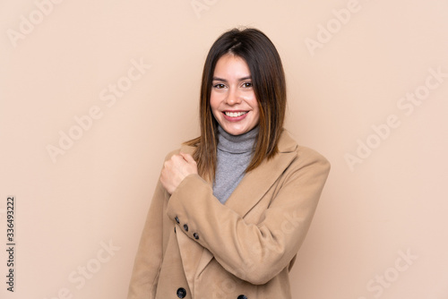 Young woman over isolated background celebrating a victory