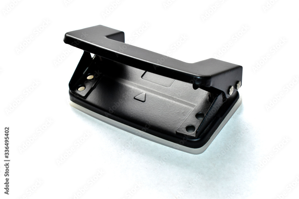 Office black hole punch on white paper Office black hole punch on white paper