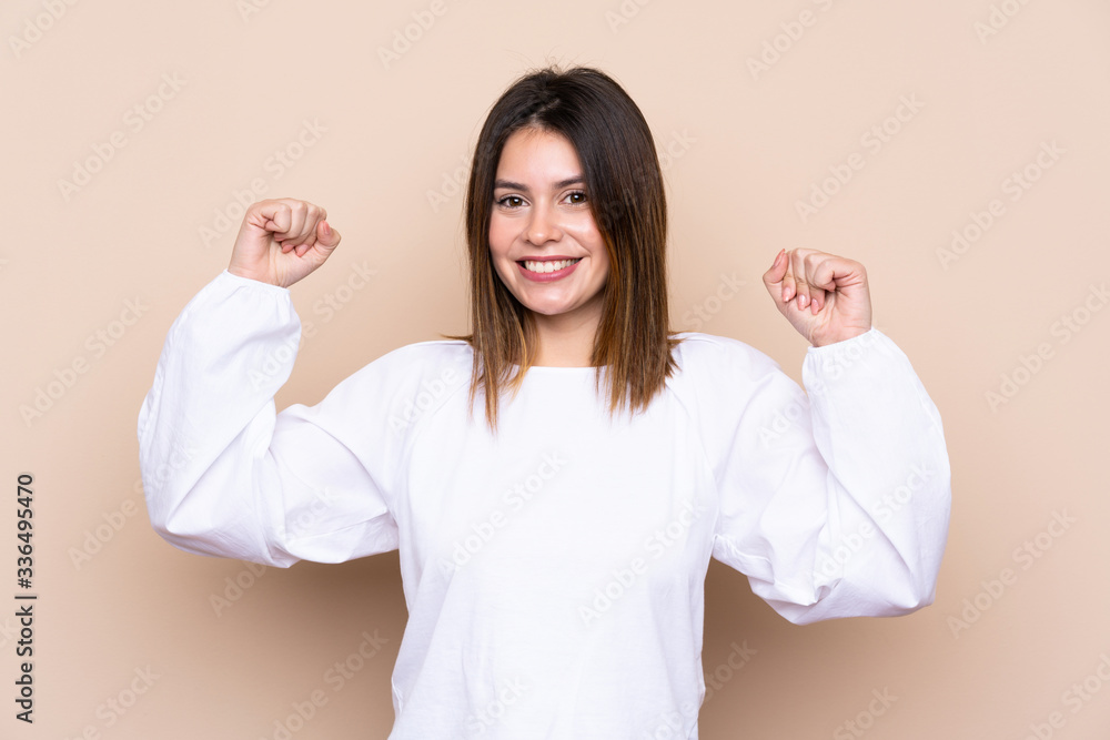 Young woman over isolated background celebrating a victory Young woman over isolated background celebrating a victory