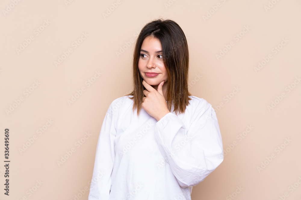 Young woman over isolated background thinking an idea Young woman over isolated background thinking an idea