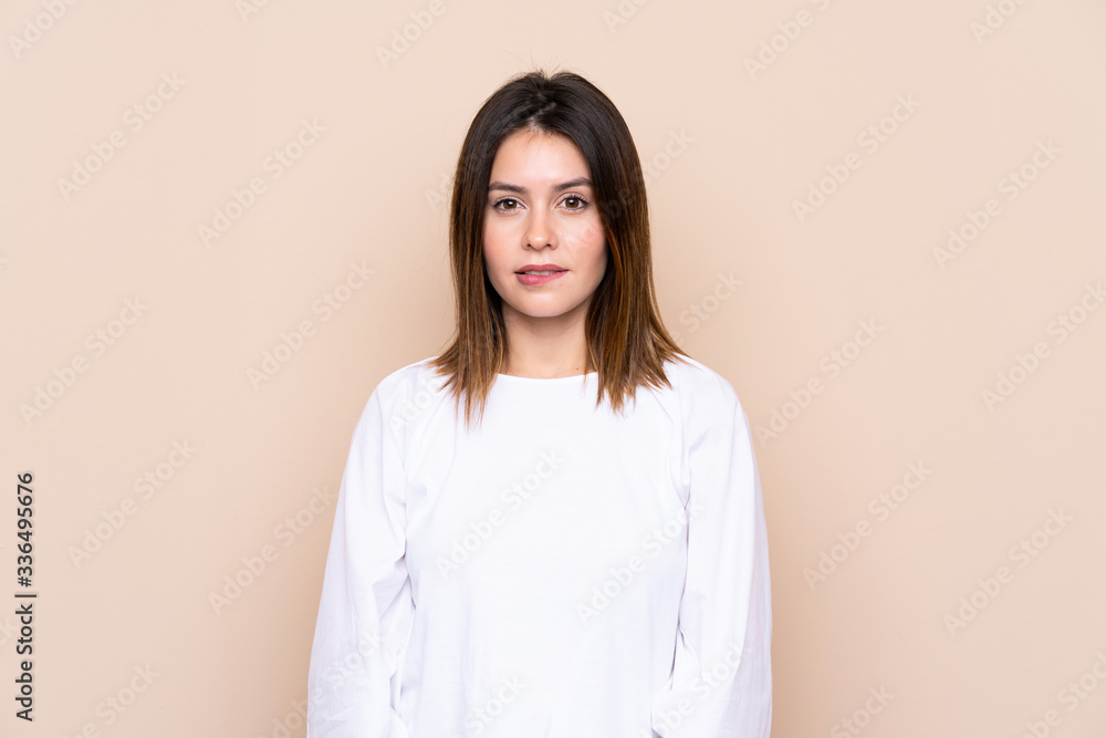 Young woman over isolated background having doubts and with confuse face expression Young woman over isolated background having doubts and with confuse face expression