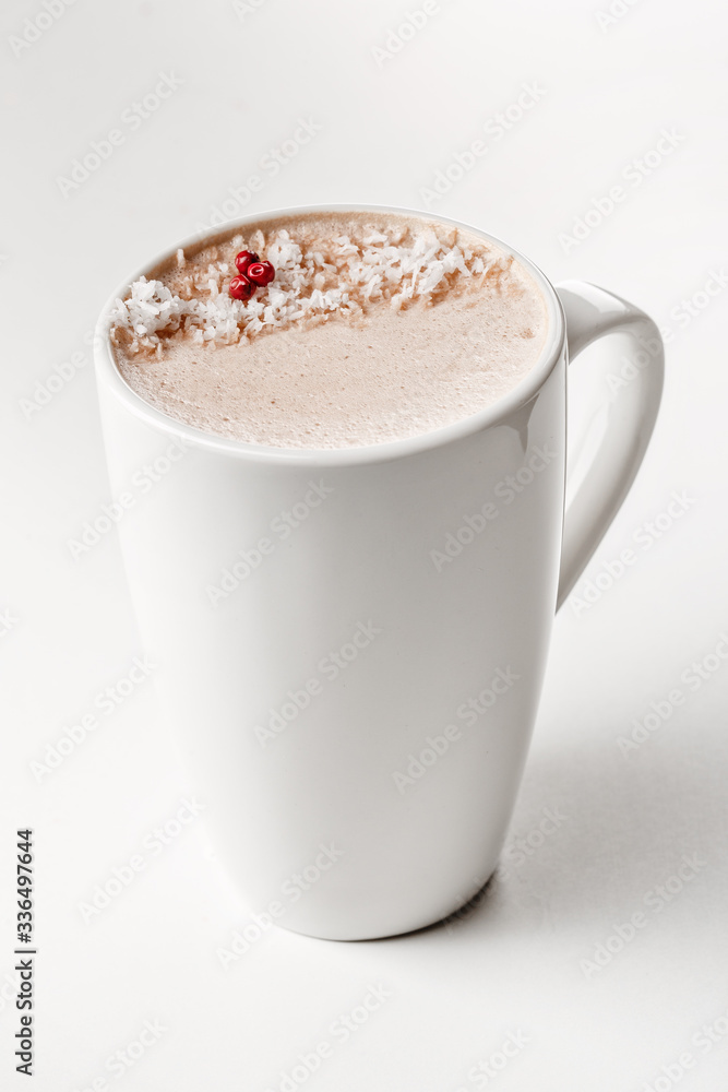 Craft latte coffee with coconut powder on top in white ceramic mug. White background. Best for commercial. Content for coffee addicted guys Craft latte coffee with coconut powder on top in white ceramic mug. White background. Best for commercial. Content for coffee addicted guys