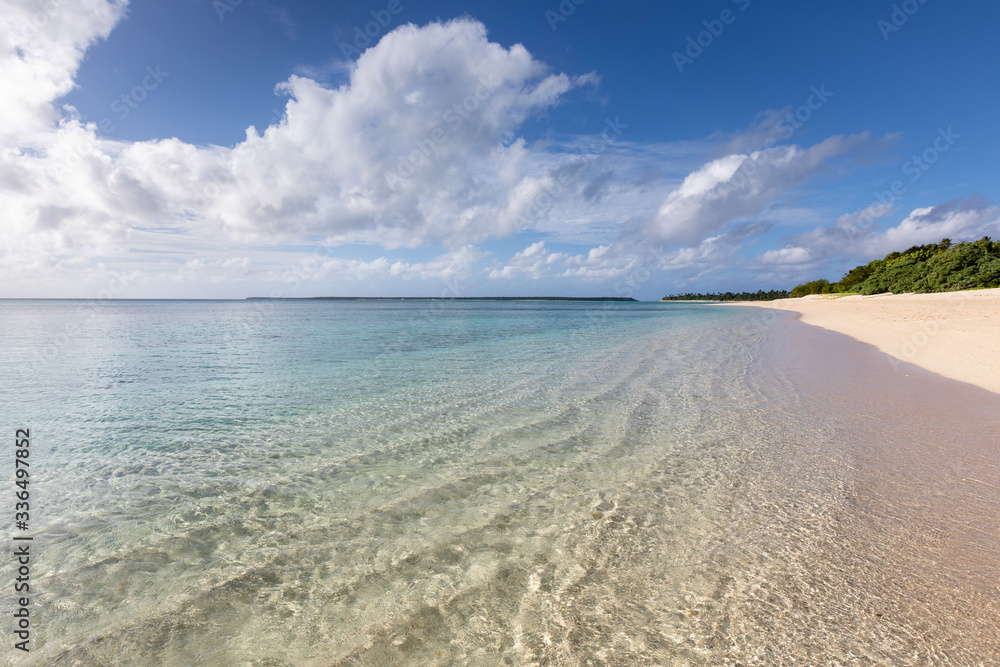 Idyllic sandy beach paradise blue lagoon transparent water fresh green trees no people sunny windless weather South Pacific Ocean Tonga Ha'apai islands