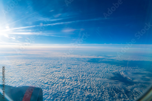 The bright sun shining in the window of an airplane