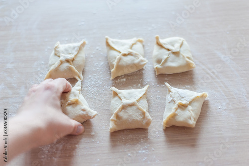 Preparation of envelopes from dough with filling. photo