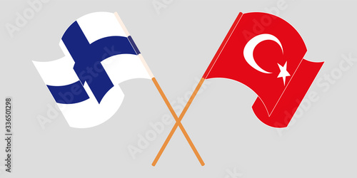 Crossed and waving flags of Turkey and Finland