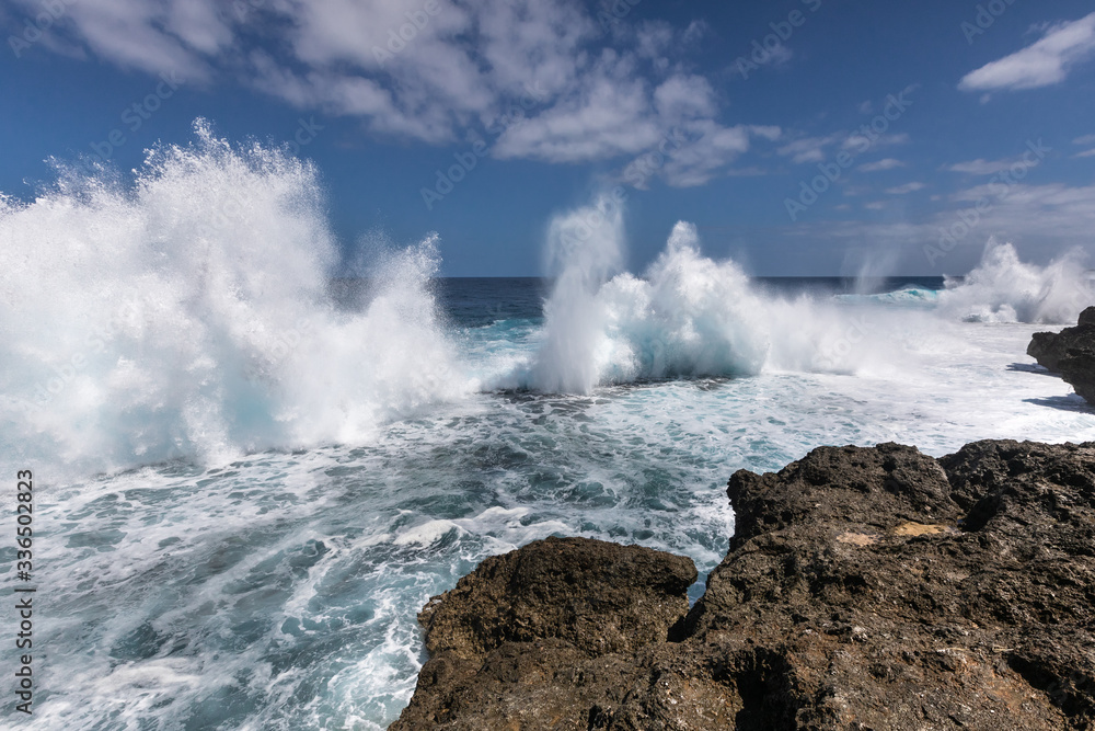 Tongatapu blowholes splashing water big 
waves limestone rocks Tonga South Pacific