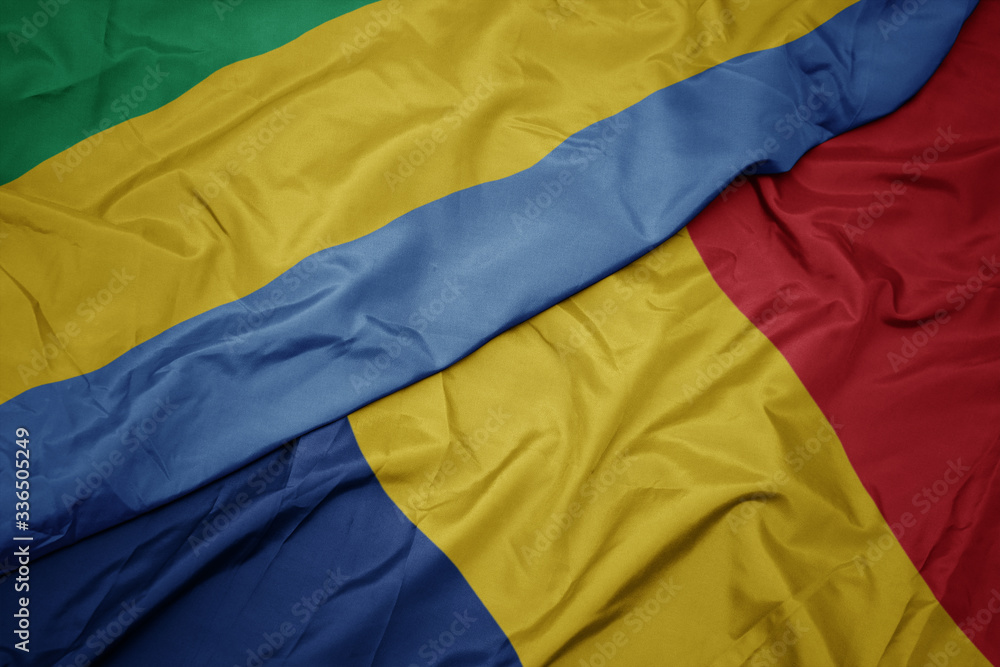 waving colorful flag of romania and national flag of gabon. waving colorful flag of romania and national flag of gabon.