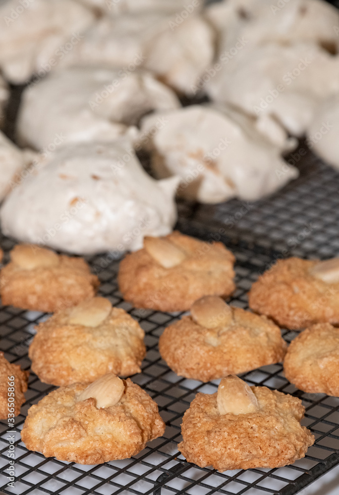 Passover (Pesach) baking - almond macaroon cookies and coconut meringue cakes, presented on a wire cooling tray. Passover (Pesach) baking - almond macaroon cookies and coconut meringue cakes, presented on a wire cooling tray.
