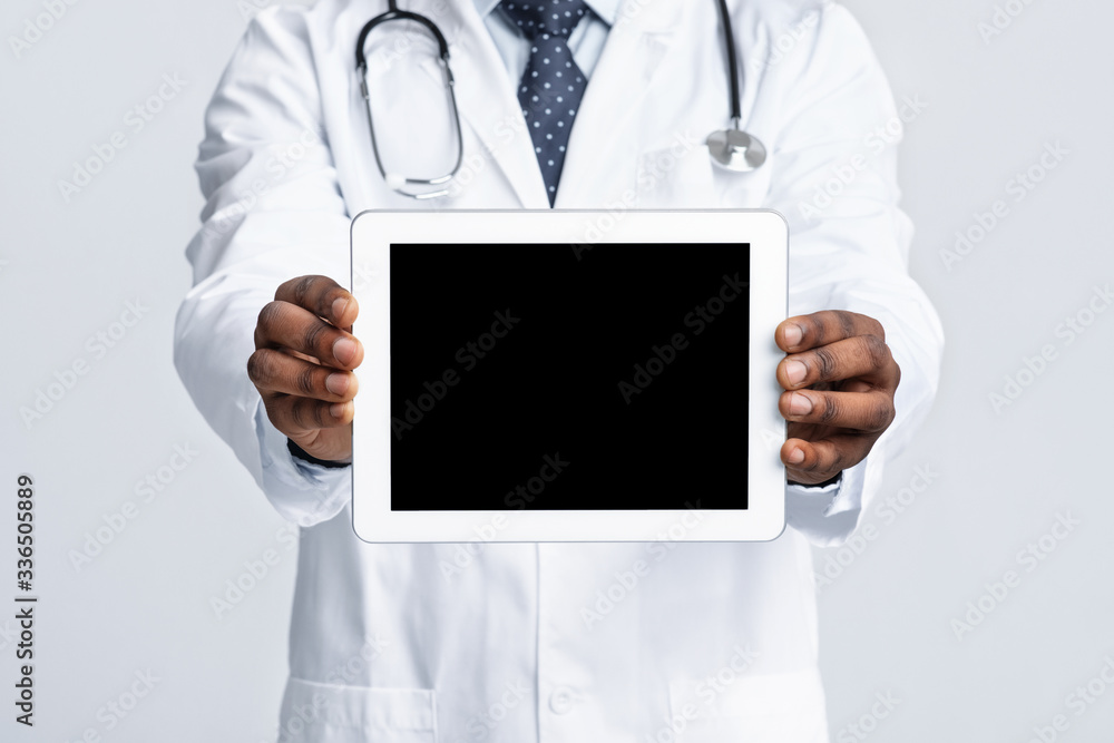 Close up of african doctor holding tablet with blank screen Close up of african doctor holding tablet with blank screen