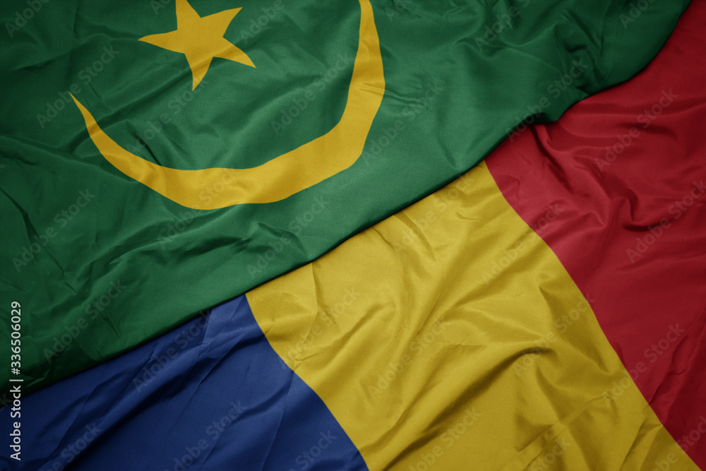 waving colorful flag of romania and national flag of mauritania.