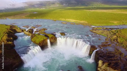 Aerial, descending, drone shot, of the Godafoss falls, the waterfall of the gods, at the Skjalfandafljot river, during golden hour, in Bardardalur, Iceland photo