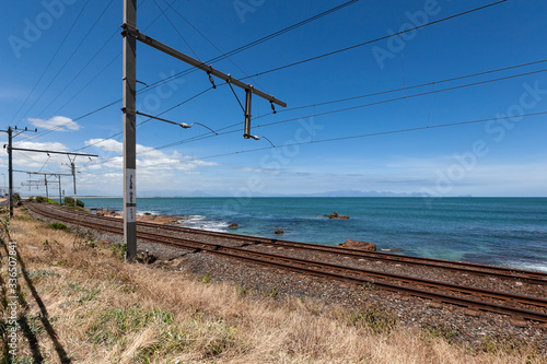 Railway along coastline. Ocean railroad in sunny day