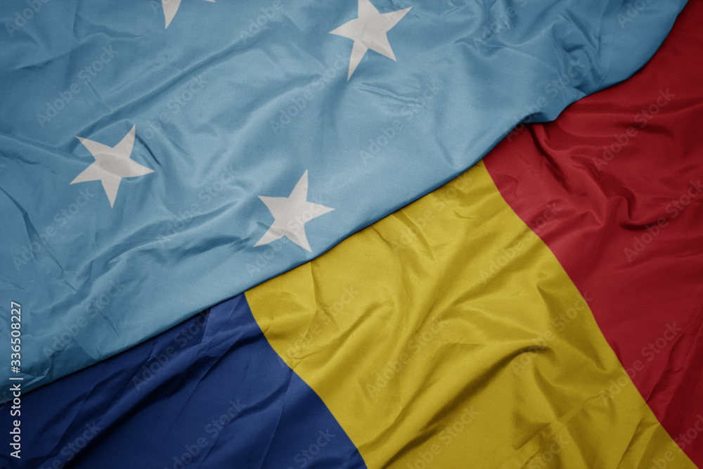waving colorful flag of romania and national flag of Federated States of Micronesia . waving colorful flag of romania and national flag of Federated States of Micronesia .