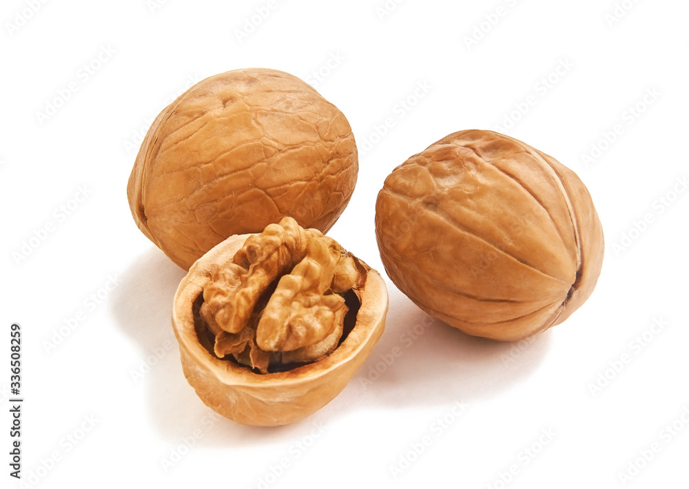 Three isolated wallnuts, one with half-open nutshell and brain-like kernel, white background Three isolated wallnuts, one with half-open nutshell and brain-like kernel, white background