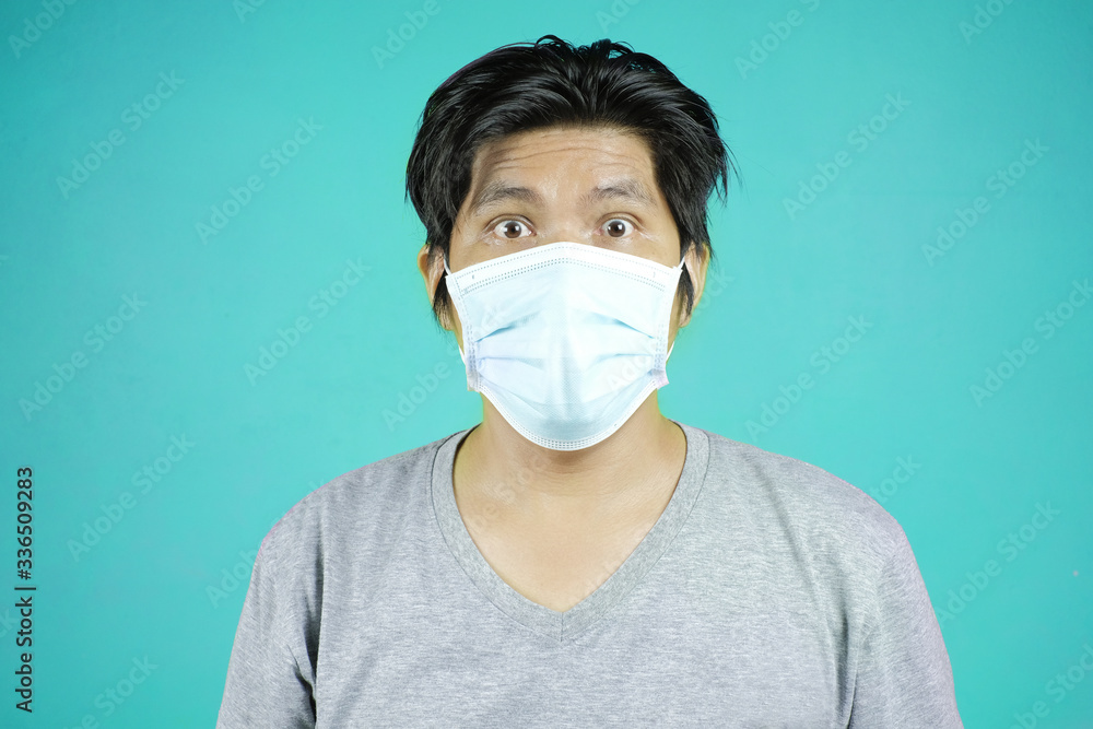 Portrait of young Asian man wearing protective mask against the coronavirus. Portrait of young Asian man wearing protective mask against the coronavirus.