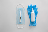 Flat lay of Coronavirus protection, medical protective masks, gloves, hand sanitizer bottles, antiseptic, disinfection, spray on white background isolated , copy space.