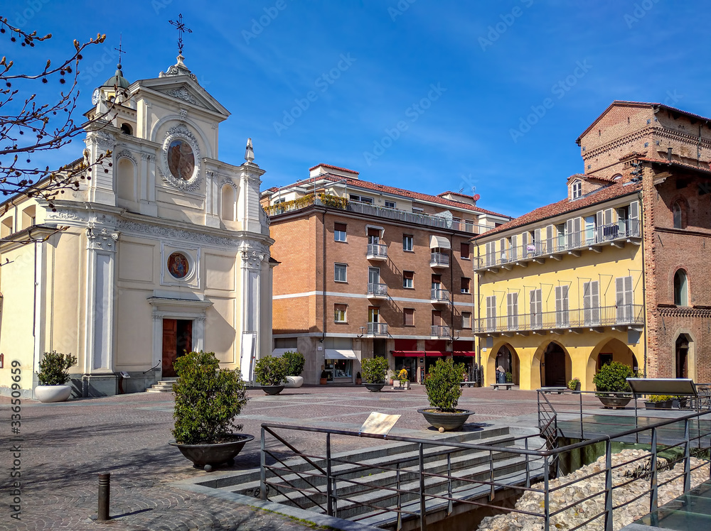 Small town square and white church in Alba, Piedmont, Italy.