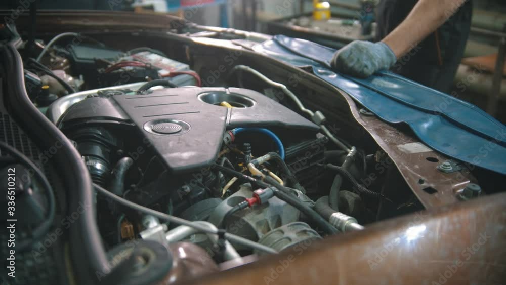 Car repair shop - working engine under the car hood