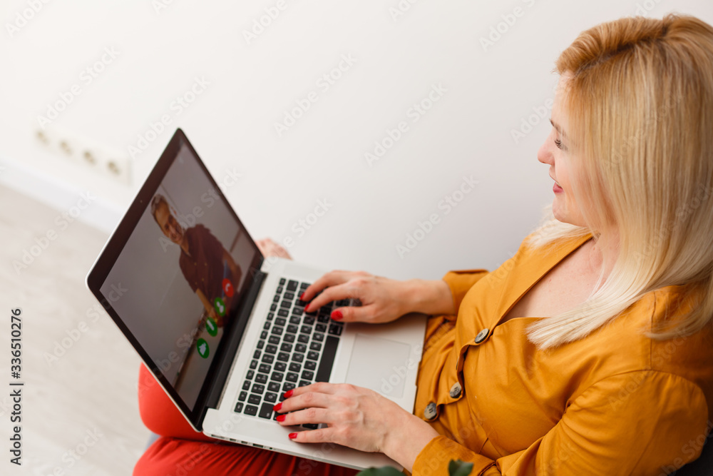 Cropped image of young female student attending online lecture on laptop at desk Cropped image of young female student attending online lecture on laptop at desk