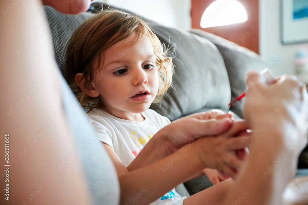A young girl gets her fingernails painted A young girl gets her fingernails painted