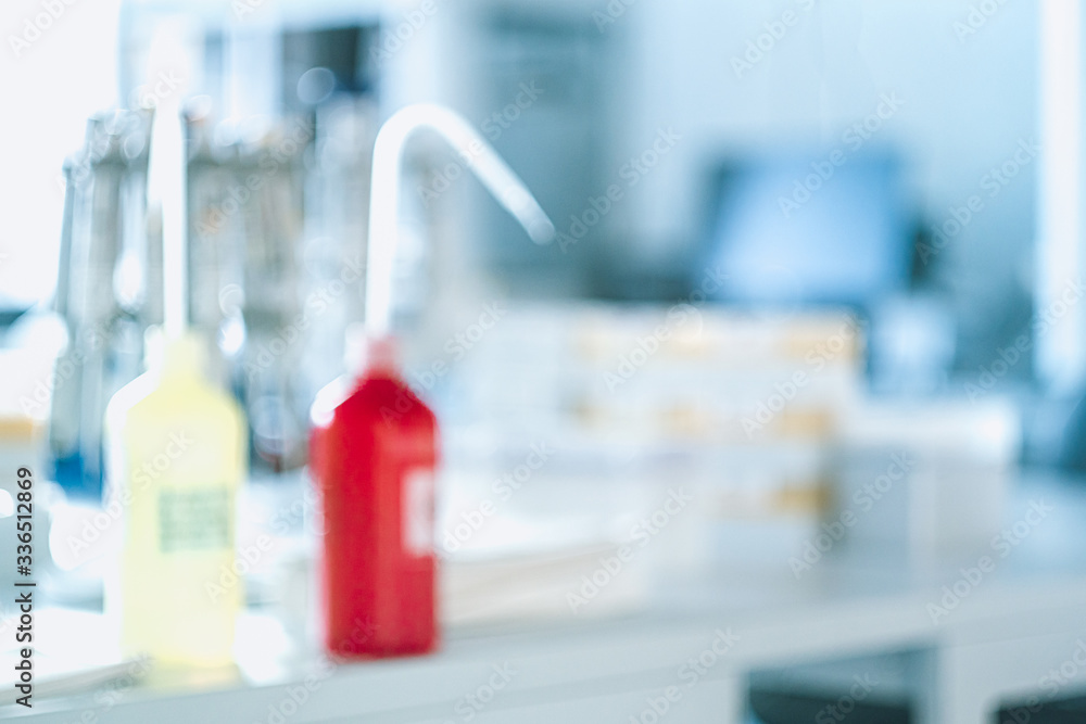 Laboratory equipment on blurred laboratory background. Research and development concept with free space for text. Laboratory equipment on blurred laboratory background. Research and development concept with free space for text.