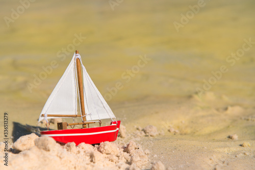 Miniature sail boat at beach