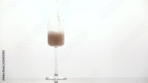 pours champagne into a glass
