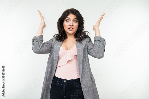 Фотография indignant girl in a classic plaid jacket on a white background
