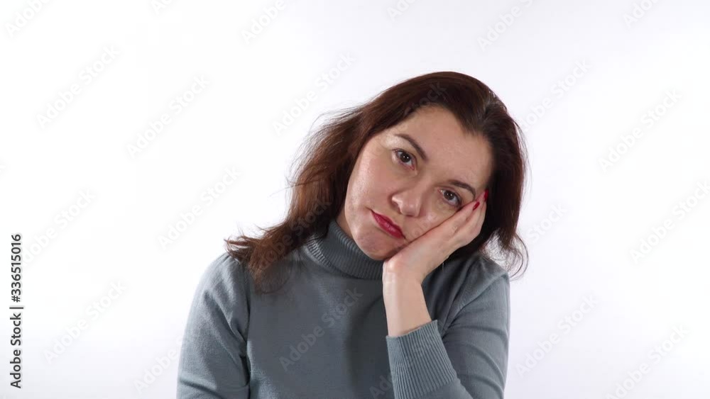Cheek gesture. Boredom gesture. Brunette caucasian woman using her hand to support head - it's signal that boredom has become. White background. Cheek gesture. Boredom gesture. Brunette caucasian woman using her hand to support head - it's signal that boredom has become. White background.