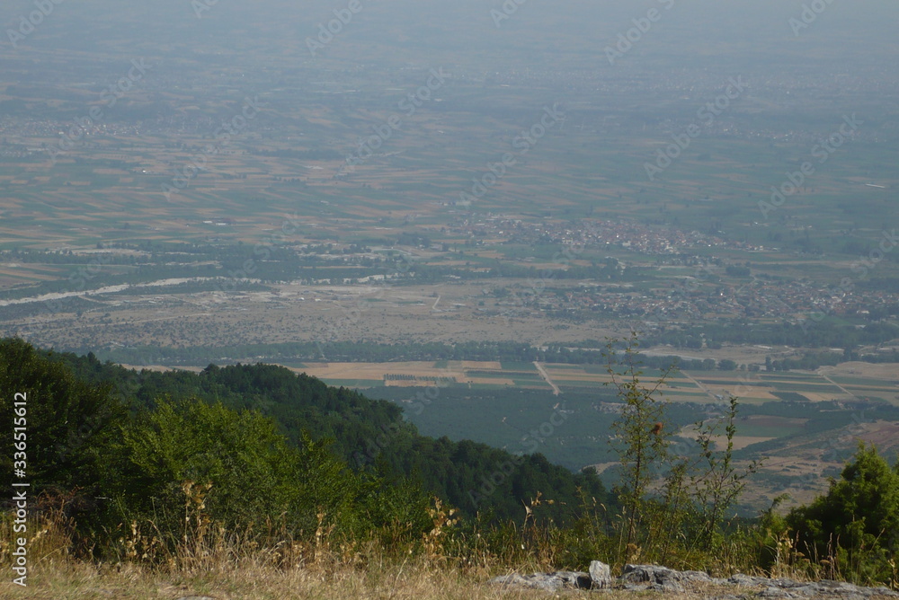 A view of a city with a mountain in the background A view of a city with a mountain in the background