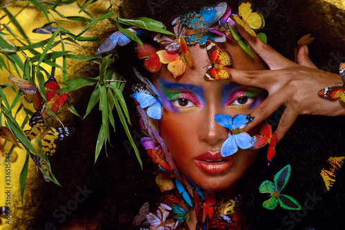 beautiful african girl surrounded by butterflies