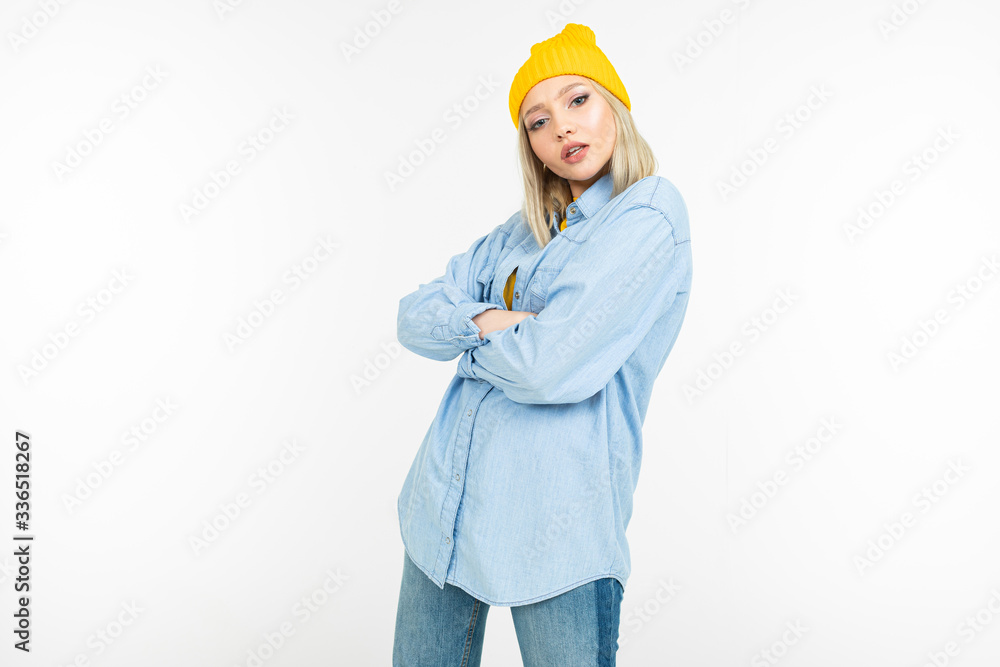 cool stylish girl in a blue shirt and yellow sweater posing on a white background cool stylish girl in a blue shirt and yellow sweater posing on a white background