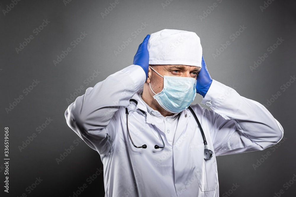 Overworked tired doctor in white uniform and medical mask. Overworked tired doctor in white uniform and medical mask.
