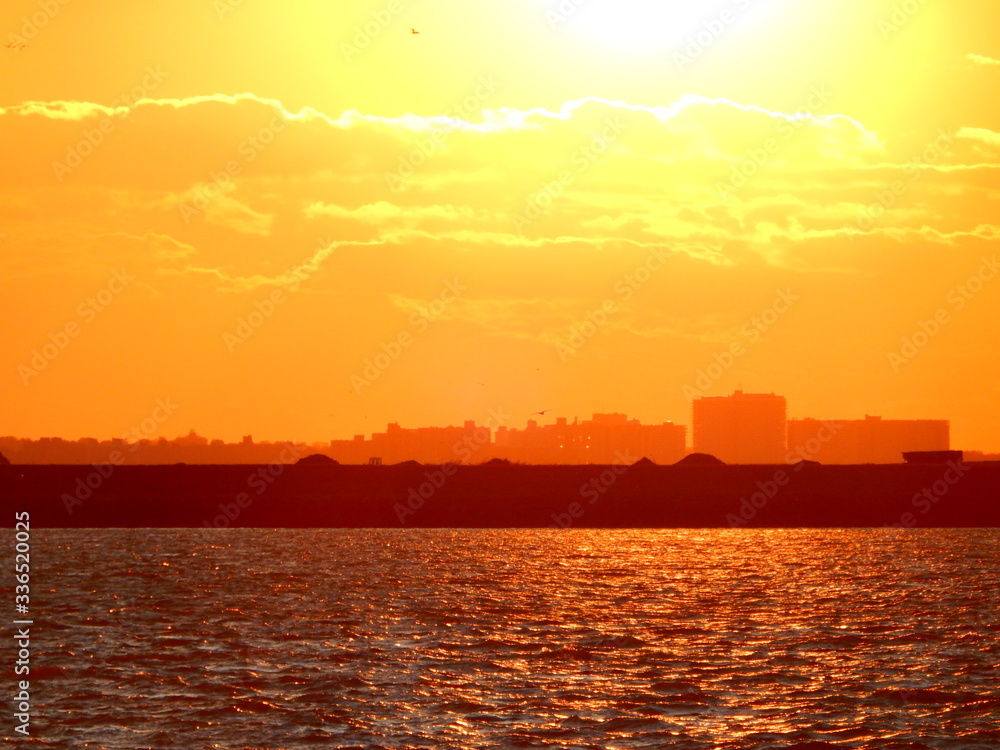 Dramatic Vivid Orange and Yellow Sunset Water Skyline