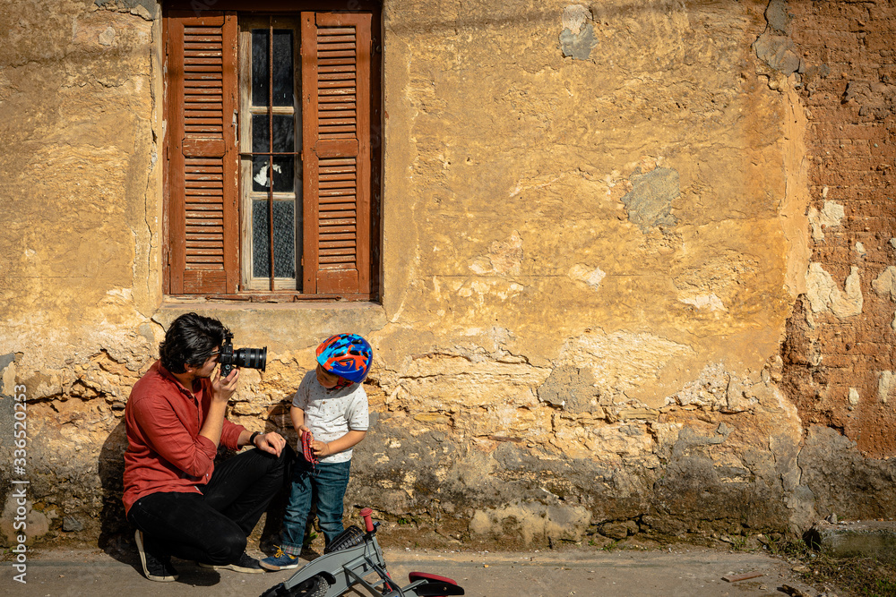 Father taking a photo of his son Father taking a photo of his son