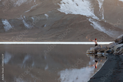 Принти на полотні fly fishing calm windless weather mountain lake western Mongolia man with spinni