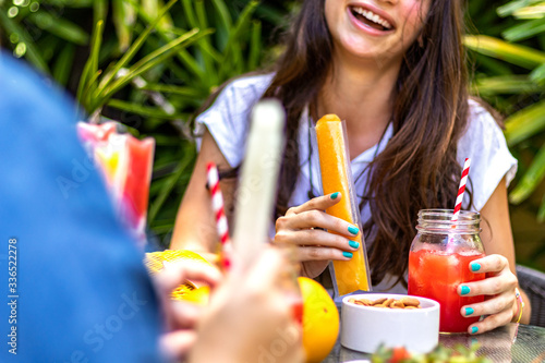 Woman laughing with a stick of fruit flavors