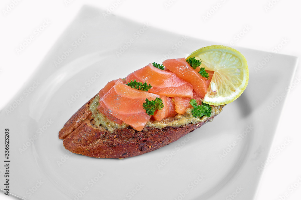 fresh sandwich with salmon vegetables on a plate on a white background fresh sandwich with salmon vegetables on a plate on a white background