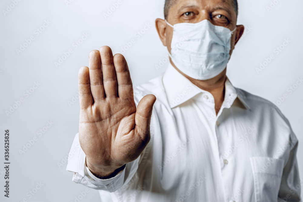  Stop world pandemia of coronavirus. Portrait of a man in shirt wearing protective mask
