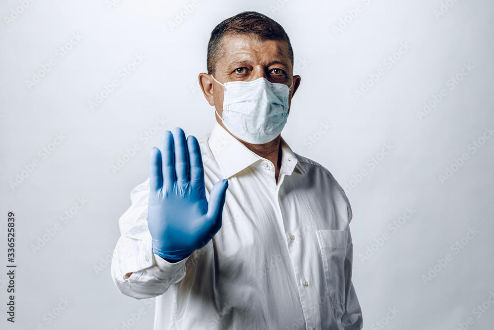  Stop world pandemia of coronavirus. Portrait of a man in shirt wearing protective mask