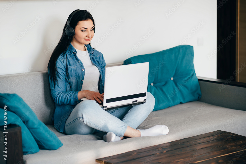 Remote work. Young woman student learning from home online using laptop and headphones. Distance learning, isolation, freelance business. Remote work. Young woman student learning from home online using laptop and headphones. Distance learning, isolation, freelance business.