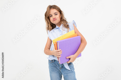girl schoolgirl with a mountain of books for knowledge isolated on white background with copy space