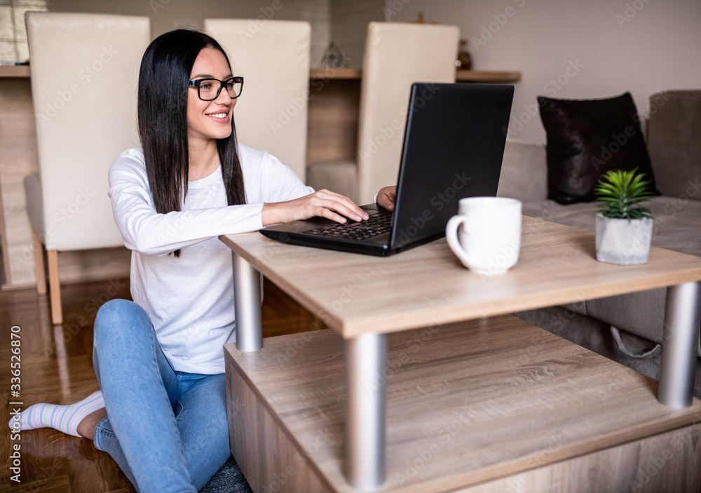 Young woman using laptop at home 