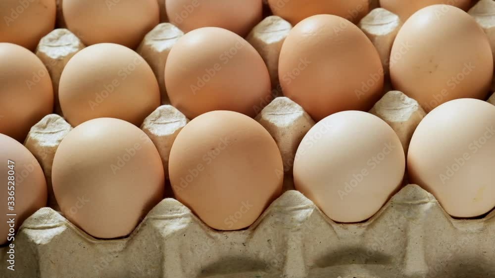 whole fresh chicken eggs in a paper tray, close up whole fresh chicken eggs in a paper tray, close up