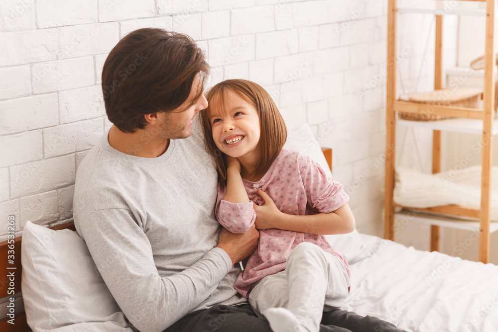 Cute little girl playing with her young dad at home Cute little girl playing with her young dad at home