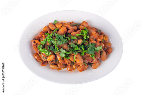 Lobio is a Georgian dish and parsley in a plate isolated on white, top view