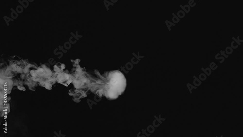 blows smoke rings on a black background